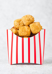 Paper container with fried crispy chicken popcorn © DenisMArt