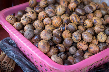 Basket full of fresh mace and nutmeg in a market in Caribbean