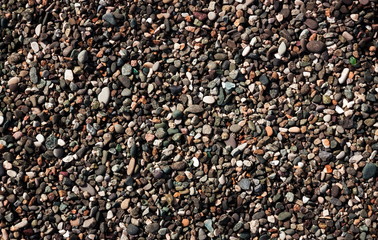 Sea stones background in sunny day