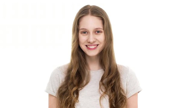 Portrait of adolescent girl 17 years old no makeup wearing t-shirt and smiling on camera with perfect teeth, isolated over white background closeup. Concept of emotions