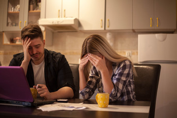 Couple receiving home bills.