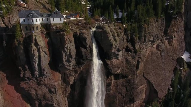 House on Cliff Revealing Gigantic Colorado Waterfall Below