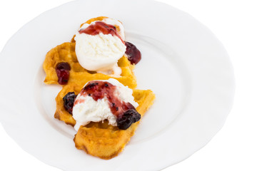 Plate of belgian waffles with ice cream and jam on white background