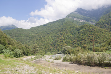 Fototapeta na wymiar The Caucasus mountains in Abkhazia. Beautiful mountain landscape with clouds