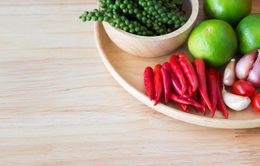 spices and herbs on wooden plate with copy space.