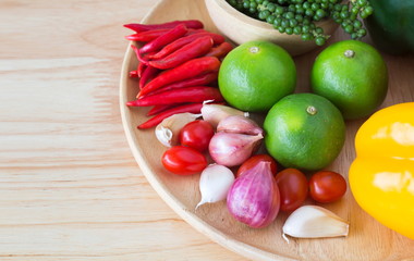spices and herbs on wooden plate.