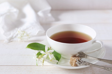 Jasmine tea in a white bone china cup on white background