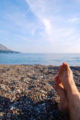 Fototapeta na wymiar mens feet on beach, vacation tourism injoy concept