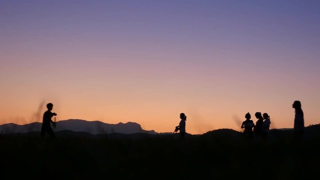 Silhouette of people before sunset