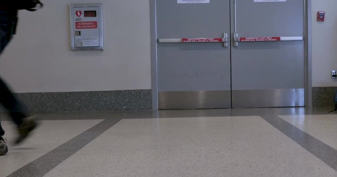 Time lapse of people walking back and forth in an airport with their luggage