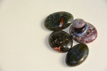 Healing palm stones isolated on light background.