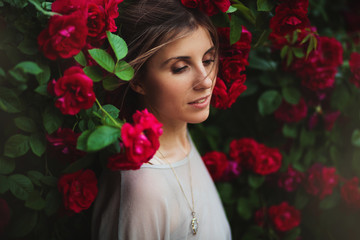 Beautiful tender woman in rose garden