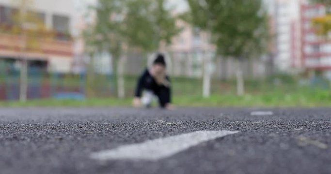 A little schoolgirl is practicing roller-skating.