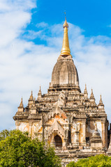 Fototapeta premium View of the facade of the building of the Shwegugyi temple in Bagan, Myanmar. Copy space for text. Vertical.