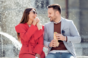Happy loving couple enjoying breakfast in the city.