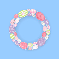 Colorful wreath with Easter eggs isolated on blue background - center text place