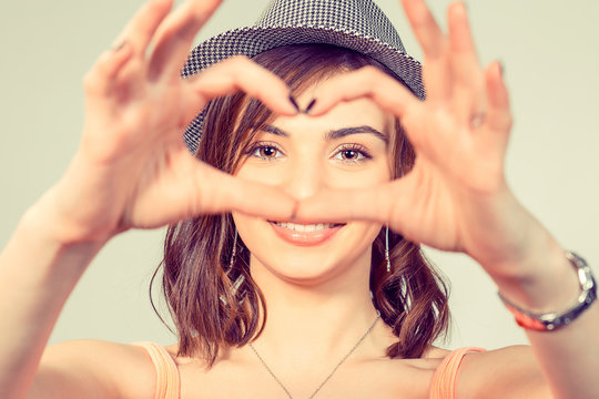 Woman making heart sign, symbol with hands.