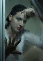 Portrait of a girl with wet hair, with a wet glass