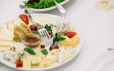 Cheese plate. Delicious cheese on a wooden table.