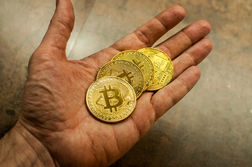 Hand holding bitcoin 2