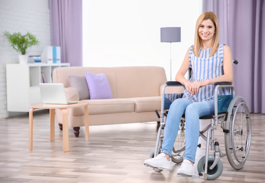 Young woman in wheelchair indoors