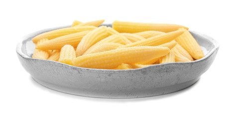 Plate with fresh young baby corn on white background