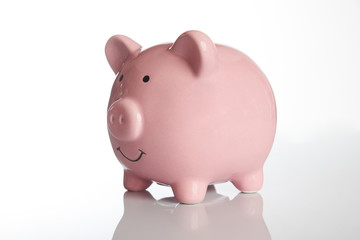 Ceramic Pink piggy bank isolated on white background with copy space, side view close-up