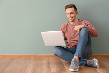 Young man using laptop indoors