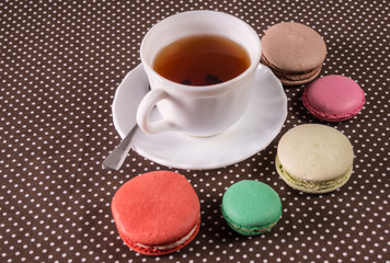  French multicolored cakes macarons and a cup of tea