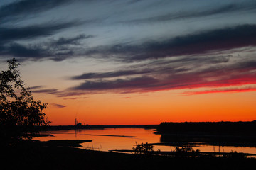 Naklejka premium Powerplants near Stanton reflected in the Missouri River after sunset