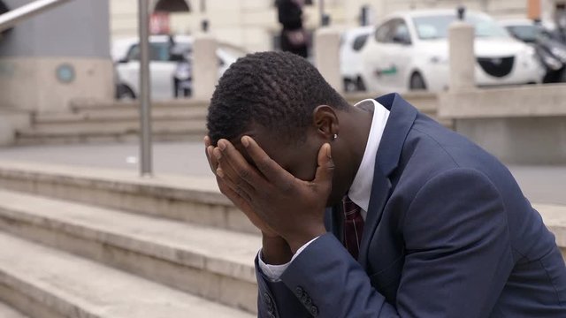 failure,business-  desperate and worried young black man in the street