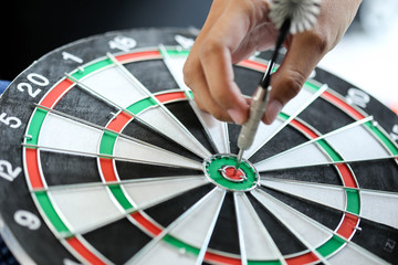 Business strategy planning success target goals,Businessman holding dart push on target.