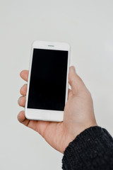 Businessman using mobile phone on light background for photo or video. Writing text, checking calls, reading messages. Close up picture of communication technology device