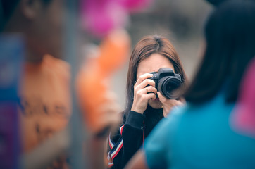 Woman photographer  holding dslr camera taking photos