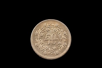 A super macro image of an old 50 Pakistani rupee coin isolated on a black background