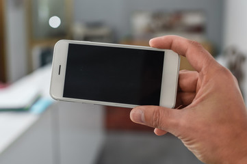 Businessman use mobile phone on light background for photo or video. Writing text, checking calls, reading messages. Close up picture of communication technology device