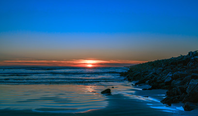 Fototapeta na wymiar Ocean Sunset Along The Jetty