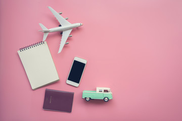 Top view of travel concept with plane, notebook, pick up vintage van, smartphone and passport