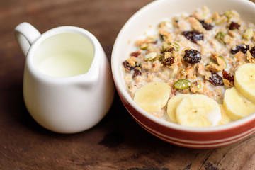 Muesli cereal with slice banana and milk