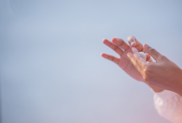 The gesture of a hand is making a raw material that is a food ingredient.