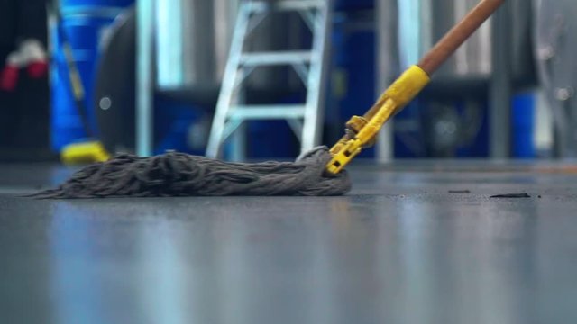 Mop on distillery floor cleaning after alcohol production
