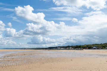 Fototapeta na wymiar Omaha Beach - clouds beach and the coastline of one of the D-Day beaches of Normandy, France