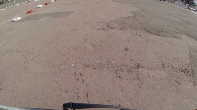 Car carefully moving around training area bypassing obstacles, driving course