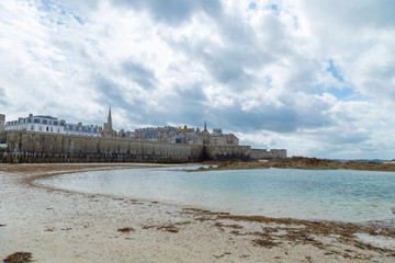 Fototapeta na wymiar Saint Malo port city Brittany, Europe with the sea bay with clear water and heavy clouds. Typical weather