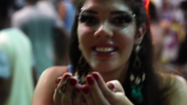 Girl blowing colorful confetti