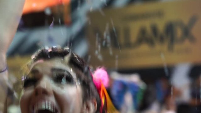 Woman Dancing and Celebrating with Confetti at Brazilian Carnival, Salvador, Bahia