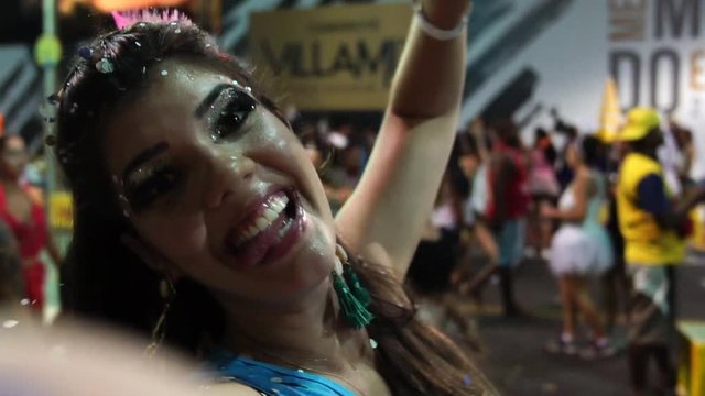 Selfie of Woman Dancing and Celebrating with Confetti at Brazilian Carnival, Salvador, Bahia