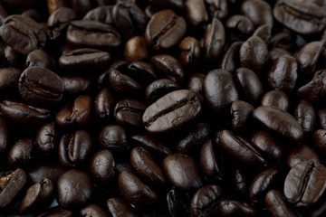 Roasted coffee beans macro. Raw materials for black coffee
