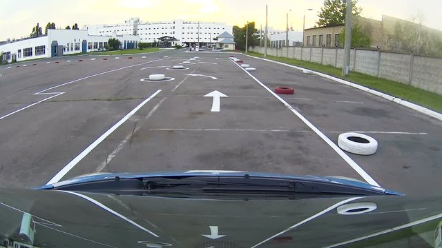Motor show client conducting test drive of new car before buying, training