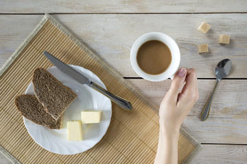 A woman having a breakfast at a table